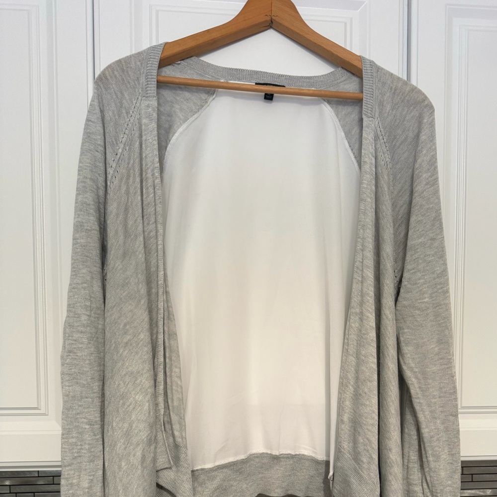 Open, light cardigan with handkerchief hem